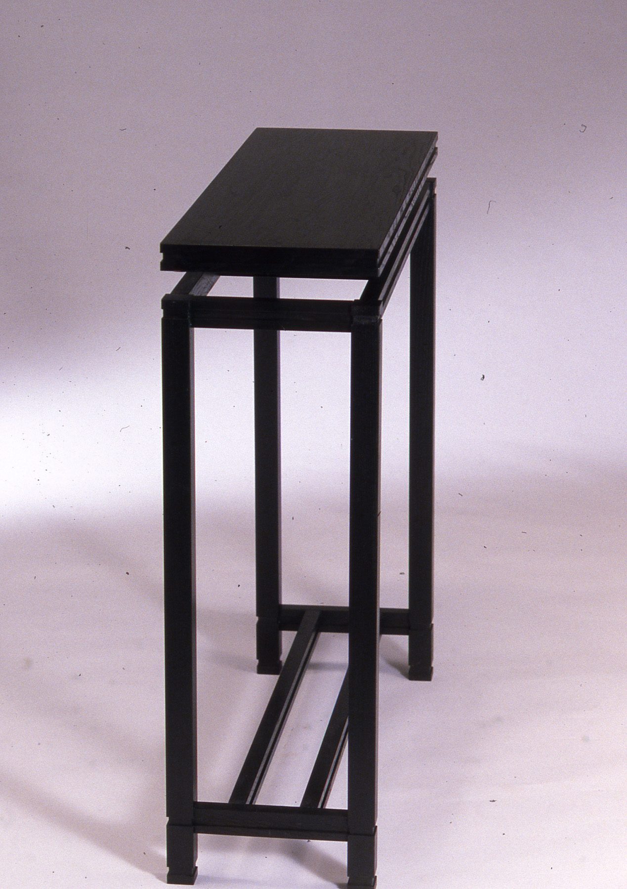 Console table, Ebonized frame, floating top, stepped lower rails