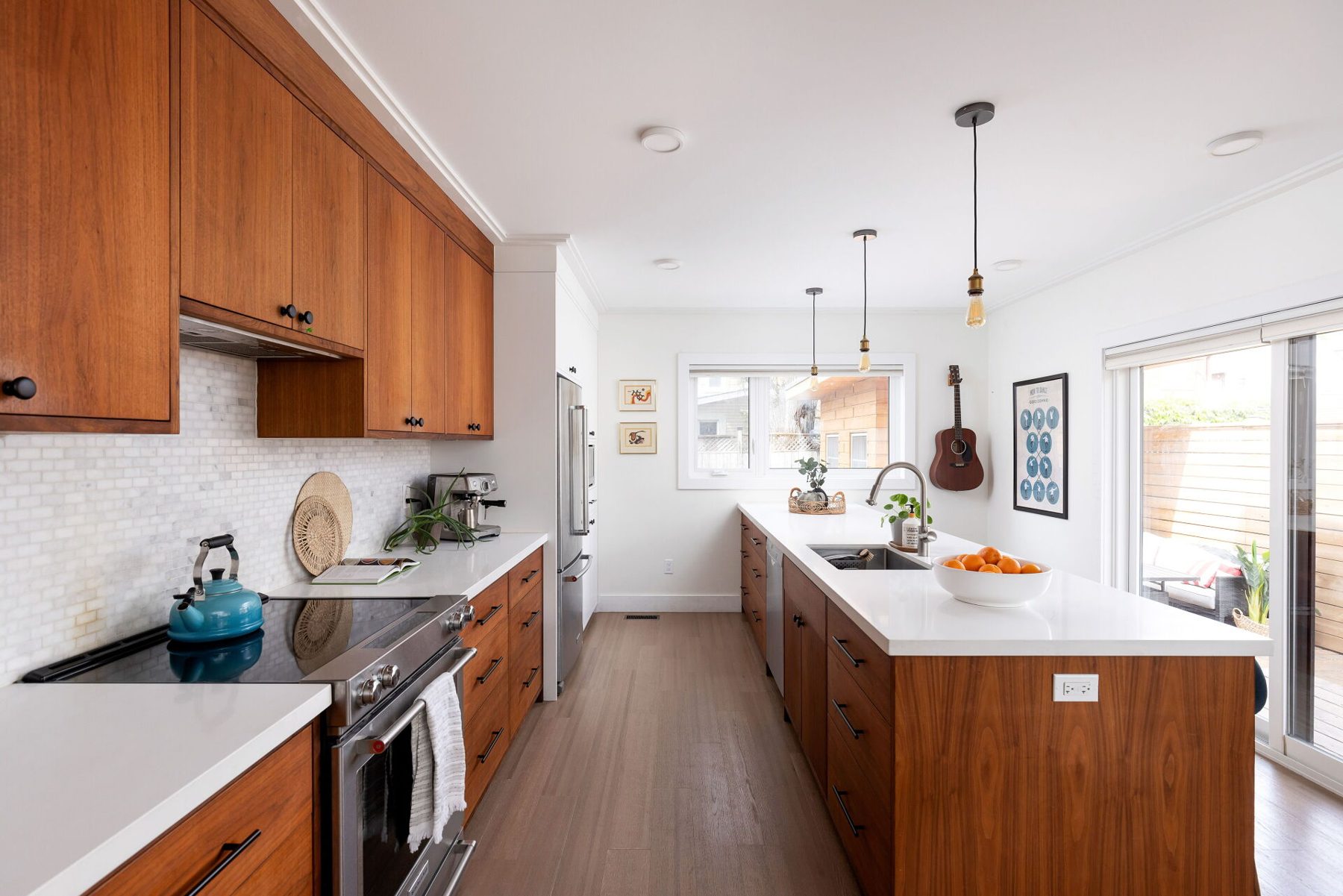 Kitchen, Walnut cabinets, slab fronts and a long island with matched grain